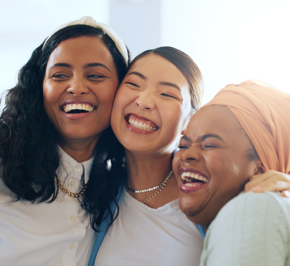 Women, happy and hug with celebration and team, diversity and success in presentation and collaboration. Solidarity, trust and business people, happiness and win in successful business meeting.